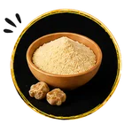 A small wooden bowl filled with hing, also known as asafoetida shown on a black background with a gold border. Two small brown capsules or pills sit beside the bowl, and three small black star-like shapes appear in the top-left corner.